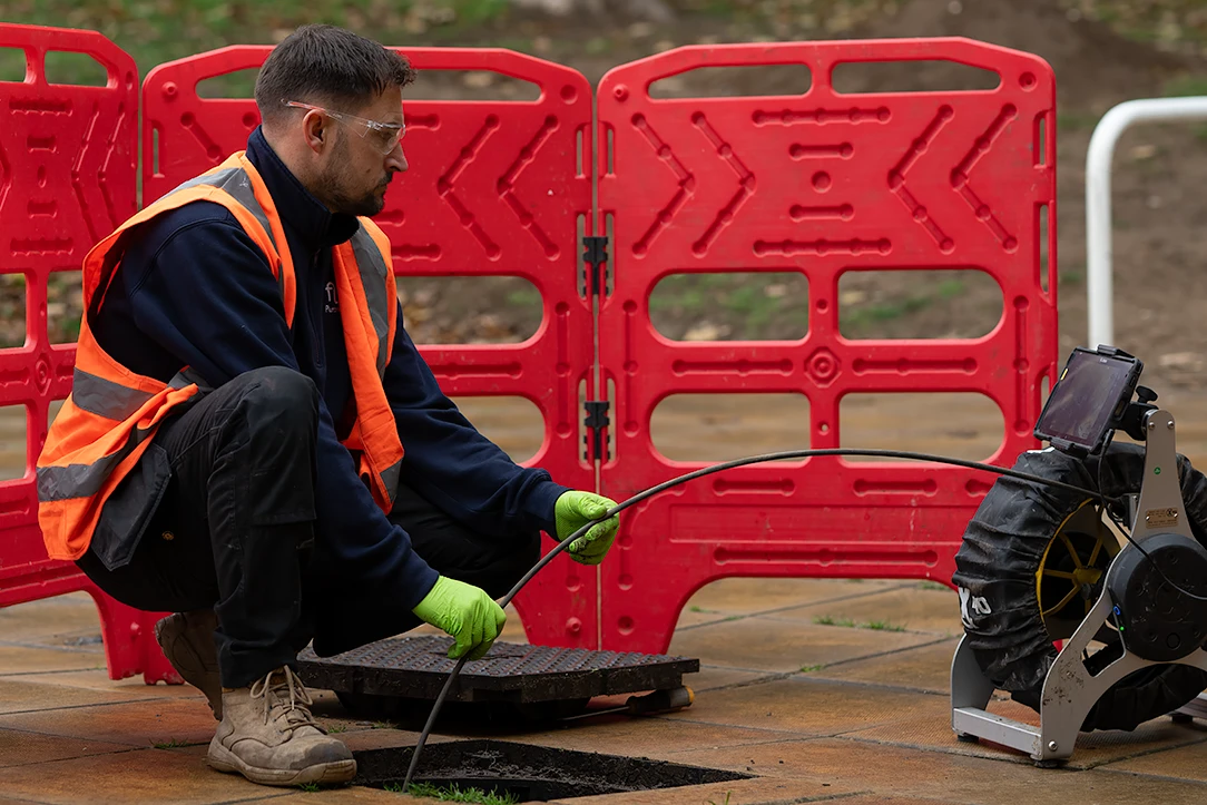 Flow Plumbing and Drainage engineer working beside a service vehicle