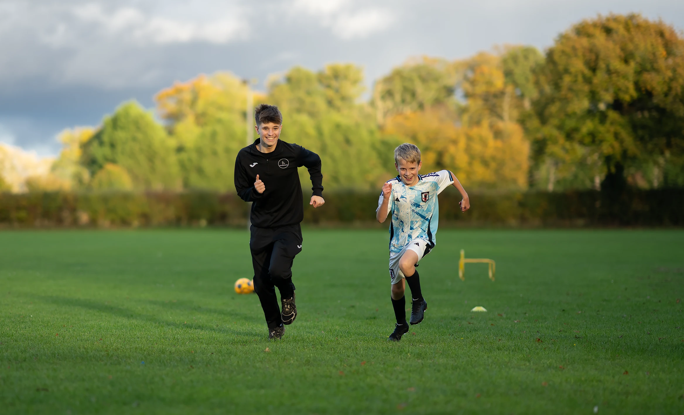 Noah from NH Football Coaching running with a young football student